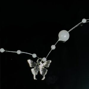 Butterfly entangled in pearl Chain